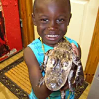 Tyree holds Wild Willy's baby alligator, Cricket