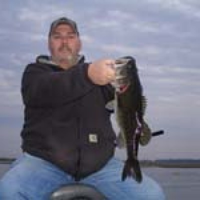 A fisherman holds a bass caught on Lake Toho