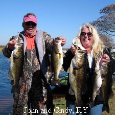 A couple poses with bass caught on Lake Toho