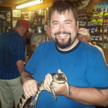A man holds a baby alligator