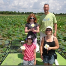 A group poses with water lilies in Lake Tohopekaliga