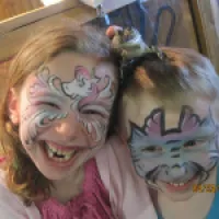 Two kids smile after facepainting