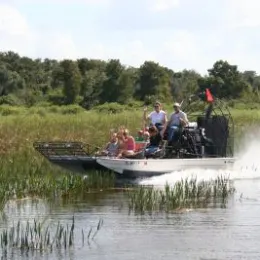 An airboat tour cruises over the Everglades